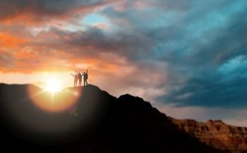 travel, tourism and people concept - group of travelers on mountain top over sunset in grand canyon national park background. group of travelers over sunset in grand canyon
