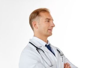 healthcare, medicine and profession concept - smiling male doctor in coat over white background. smiling doctor in white coat at medical office