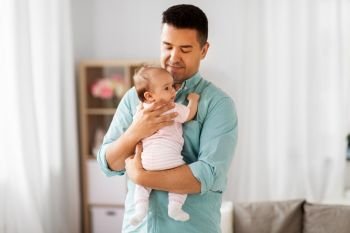 family, parenthood and fatherhood concept - middle aged father with little baby daughter at home. middle aged father with baby daughter at home