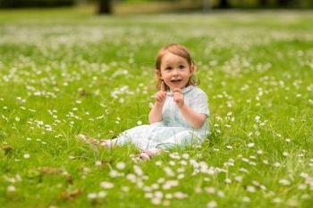 childhood, leisure and people concept - happy little baby girl at park in summer. happy little baby girl at park in summer