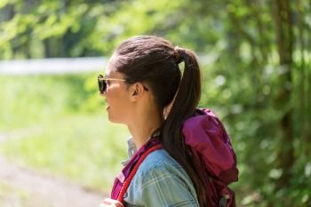 travel, tourism, hike and people concept - happy young woman with backpack outdoors. happy young woman with backpack hiking