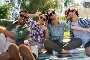 leisure, fun and people concept - happy friends taking selfie outdoors in summer park. happy friends taking selfie outdoors in summer