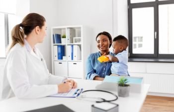 medicine, healthcare and pediatry concept - happy african american mother with baby son and caucasian doctor at clinic. happy mother with baby son and doctor at clinic