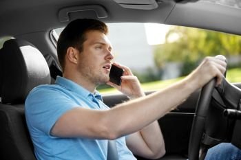 transport, vehicle and people concept - man or driver driving car and calling on smartphone. man driving car and calling on smartphone