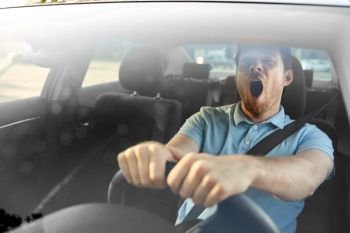 transport, vehicle and driving concept - tired sleepy man or car driver yawning. tired sleepy man or driver driving car and yawning