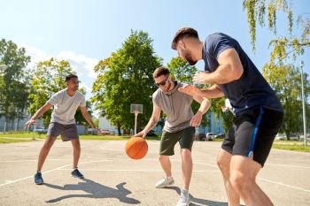 sport, leisure games and male friendship concept - group of men or friends playing street basketball. group of male friends playing street basketball