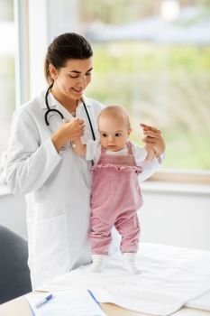 medicine, healthcare and pediatrics concept - female pediatrician or neuropathist doctor or nurse checking baby girl patient’s health at clinic or hospital. female pediatrician doctor with baby at clinic