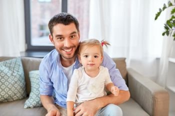 family, parenthood and fatherhood concept - father with little baby daughter at home. father with little baby daughter at home