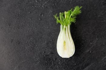 vegetable, food and culinary concept - fennel on slate stone background. fennel on table on slate stone background