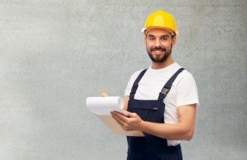 profession, construction and building concept - happy smiling male worker or builder in helmet with clipboard over grey concrete background. male worker or builder in helmet with clipboard