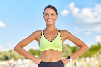 people, sport and fitness concept - portrait of smiling young sporty woman outdoors. portrait of smiling young sporty woman outdoors