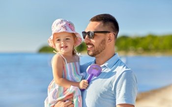 family, fatherhood and leisure concept - happy smiling father with little daughter on beach. happy father with little daughter on beach