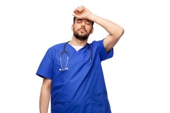 healthcare, profession and medicine concept - tired doctor or male nurse in blue uniform with stethoscope over white background. tired doctor or male nurse with stethoscope