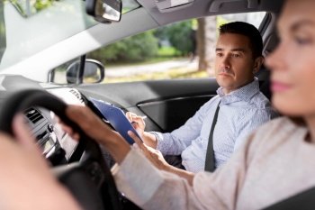 driver courses, exam and people concept - young woman and driving school instructor with clipboard talking in car. car driving school instructor and young driver