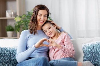 people, family and love concept - happy smiling mother with daughter at home. happy smiling mother with daughter at home