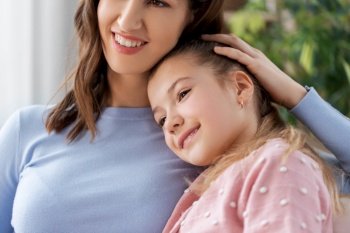 people, family and love concept - happy smiling mother with daughter at home. happy smiling mother with daughter at home