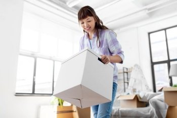 moving, people and real estate concept - happy smiling asian woman holding box with stuff at new home. happy woman unpacking boxes and moving to new home
