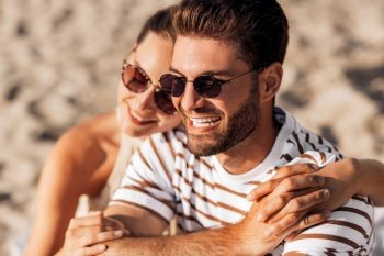 love, summer holidays and people concept - close up of happy smiling couple chilling on beach. happy couple chilling on summer beach