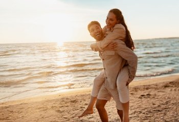 leisure and people concept - happy couple having fun on summer beach. happy couple having fun on summer beach