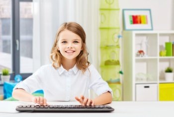 education, school and technology concept - happy smiling student girl with keyboard over home room background. happy student girl with keyboard at home
