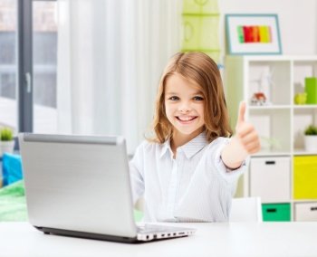 education, school and technology concept - happy smiling student girl with laptop computer learning online and showing thumbs up over home room background. smiling student girl with laptop showing thumbs up