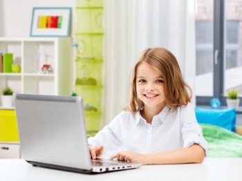 education, school and technology concept - happy smiling student girl with laptop computer learning online over home room background. smiling student girl with laptop computer at home