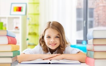 education and school concept - happy smiling student girl with books learning over home room background. smiling student girl with books learning at home