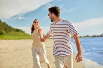 summer holidays, leisure and people concept - happy couple running along beach. happy couple running along summer beach