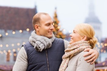 winter holidays and people concept - happy couple over christmas market background. happy couple at christmas market
