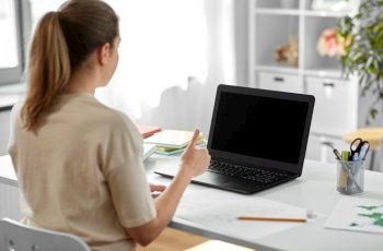 education, online school and distant learning concept - student woman with laptop computer and pencil drawing showing thumbs up at home. student woman with laptop and drawing at home
