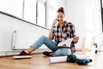 repair, people and real estate concept - woman with clipboard calling on smartphone sitting on floor at home. woman with clipboard calling on phone at home