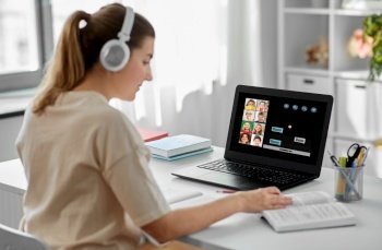 education, school and distant learning concept - female teacher in headphones with laptop computer and book having online class with little students at home. female teacher with laptop having online class