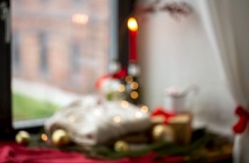 winter holidays, celebration and background concept - blurred still life of christmas decorations on window sill at home. blurred background of christmas decor on window