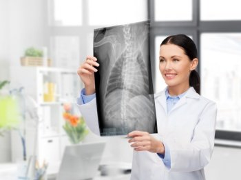 medicine, pet and healthcare concept - happy smiling female veterinarian doctor looking at animal’s x-ray over vet clinic office background. veterinarian with animal’s x-ray at vet clinic