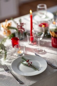 winter holidays, dinner party and celebration concept - close up of christmas table serving at home. christmas dinner party table serving at home