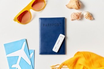 travel, tourism and pandemic concept - negative coronavirus test, passport, air tickets and sunglasses with seashells on white background. negative coronavirus test, passport and tickets