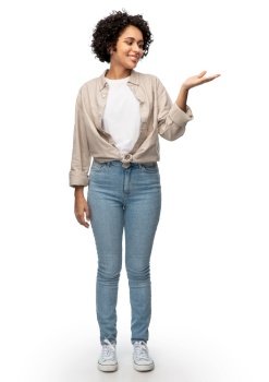 people, ethnicity and portrait concept - happy smiling woman in shirt and jeans holding something imaginary on her hand over white background. happy smiling woman holding something on her hand