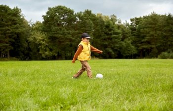 childhood, leisure games and people concept - little boy with soccer ball at summer park. little boy with soccer ball at park