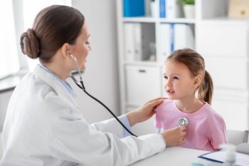 medicine, healthcare and pediatry concept - female doctor or pediatrician with stethoscope and little girl patient on medical exam at clinic. doctor with stethoscope and girl patient at clinic