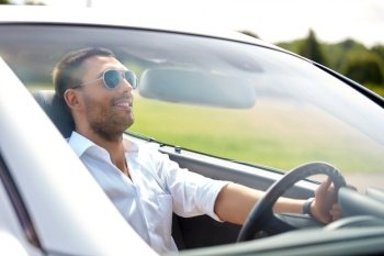 transport, leisure and people concept - happy man in sunglasses driving convertible car. happy man in sunglasses driving convertible car