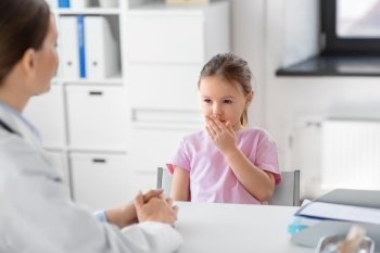medicine, healthcare and pediatry concept - female doctor or pediatrician and coughing little girl patient on medical exam at clinic. doctor and little girl patient coughing at clinic