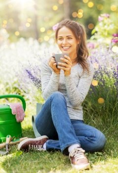 gardening and people concept - young woman drinking tea or coffee at summer garden. woman drinking tea or coffee at summer garden
