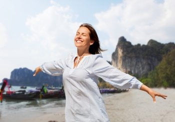 travel, tourism and vacation concept - happy smiling woman over tropical beach background in french polynesia. happy smiling woman on tropical beach