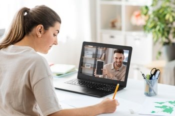 school, education and distance learning concept - female student with teacher on laptop computer screen having video call or online class at home. student with laptop having online class at home