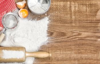 Dough preparation. Food background. Baking tools and ingredients on wooden table