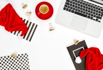 Office workplace with laptop computer, coffee and Christmas decoration. Business holidays flat lay for social media