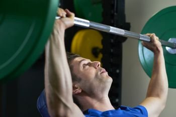 Man In Gym Lifting Heavy Weights On Bar