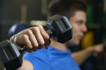 Man In Gym Exercising With Weights