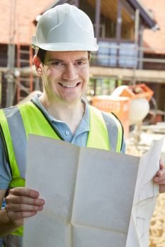 Portrait Of Construction Worker On Building Site Looking At House Plans
