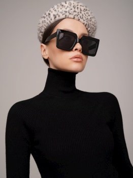 Beautiful young lady in a black turtleneck. Refined taste. Elegance. Leopard print beret